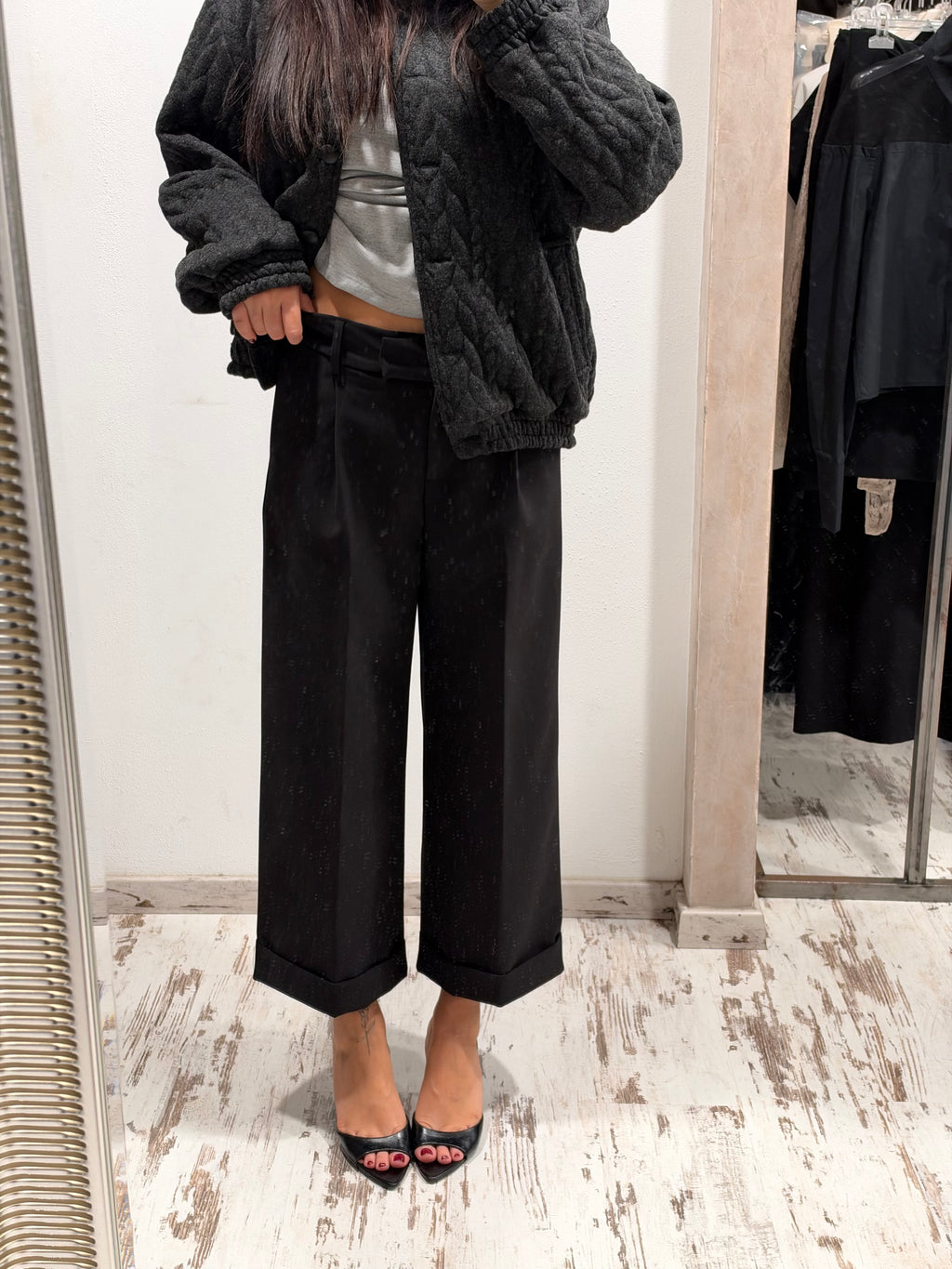 Pantaloni neri a gamba ampia con cintura e piega frontale